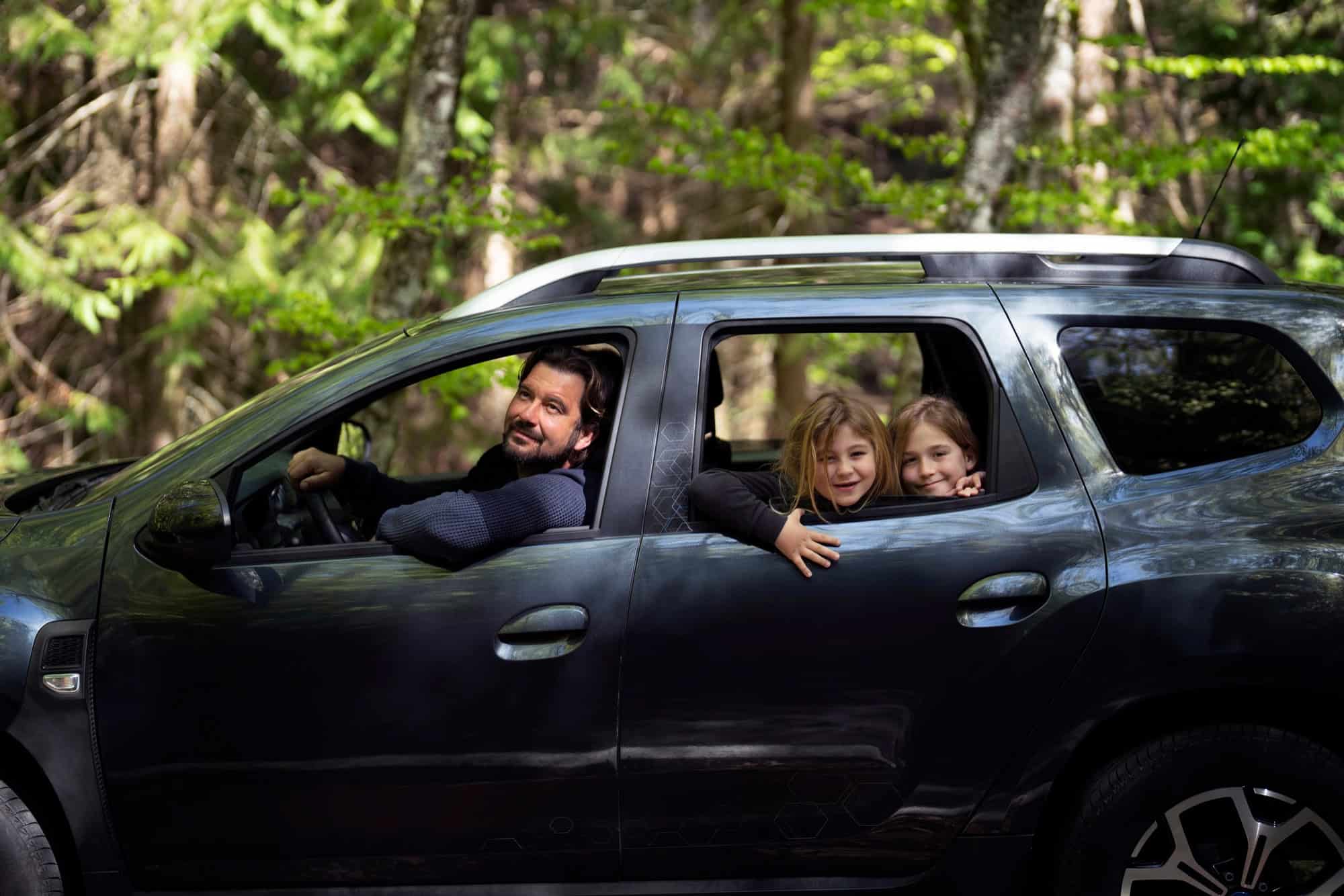 Comfortable family car rental adventure in lush forest setting with Safe Drive Car Rentals.